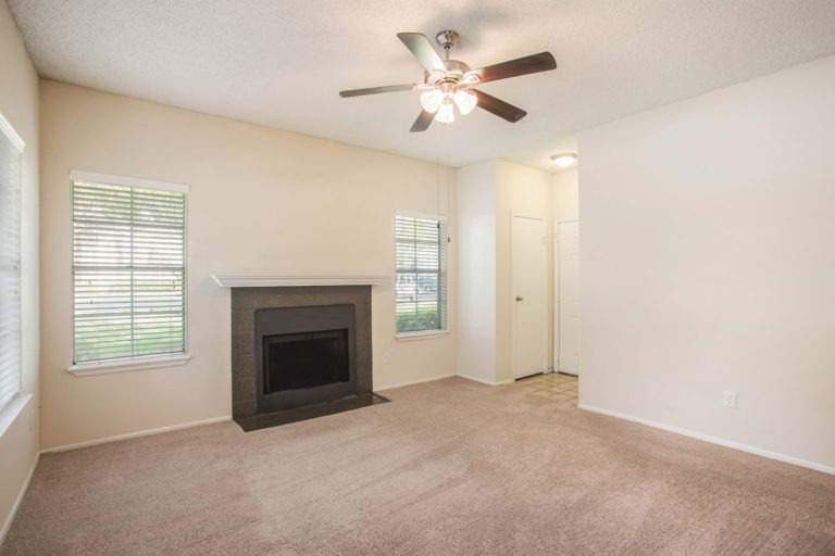 Carpeted living room with fireplace