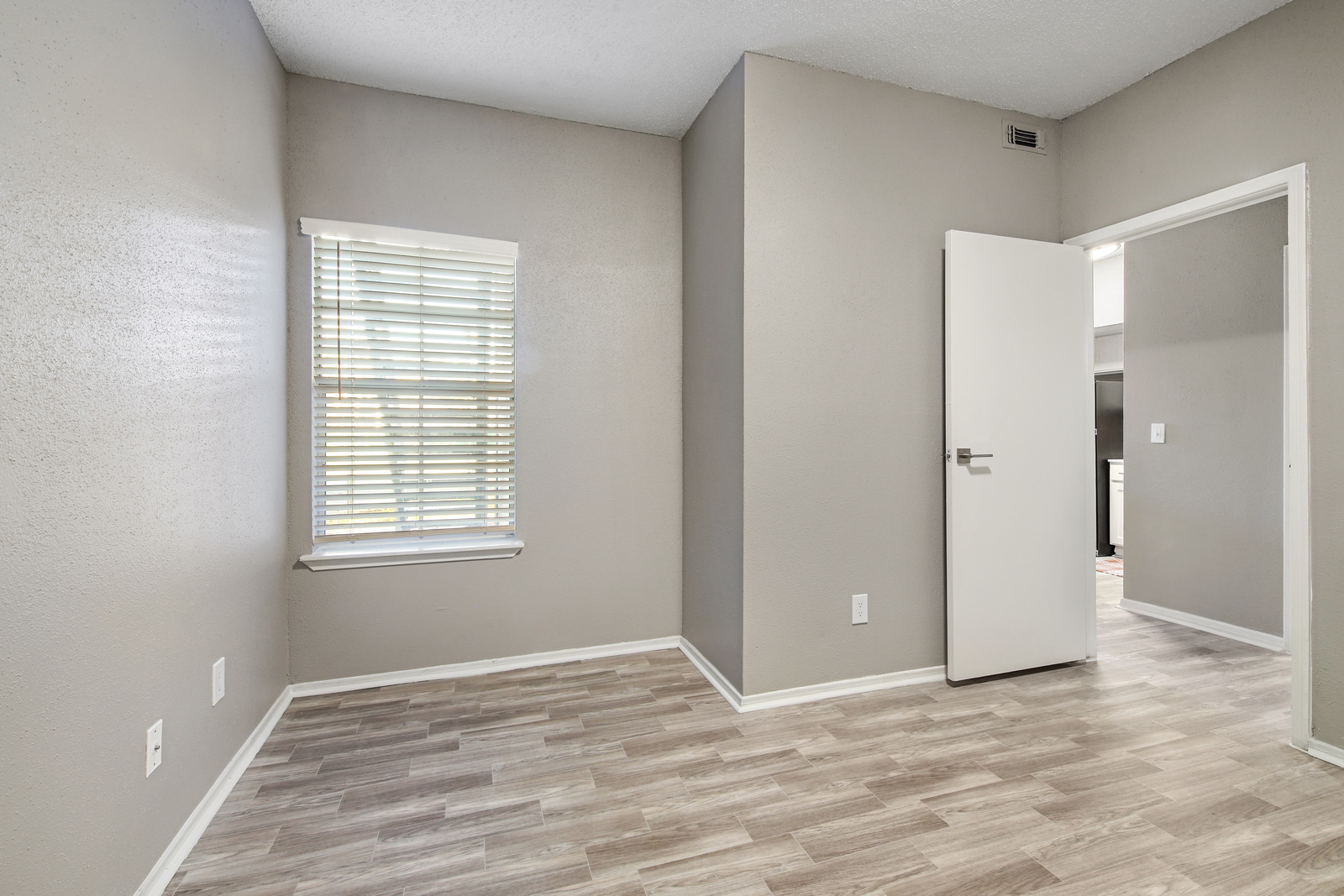 Empty bedroom with vinyl wood looking floors