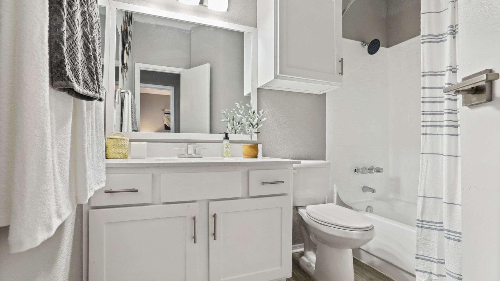 Bathroom with white cabinets and tub