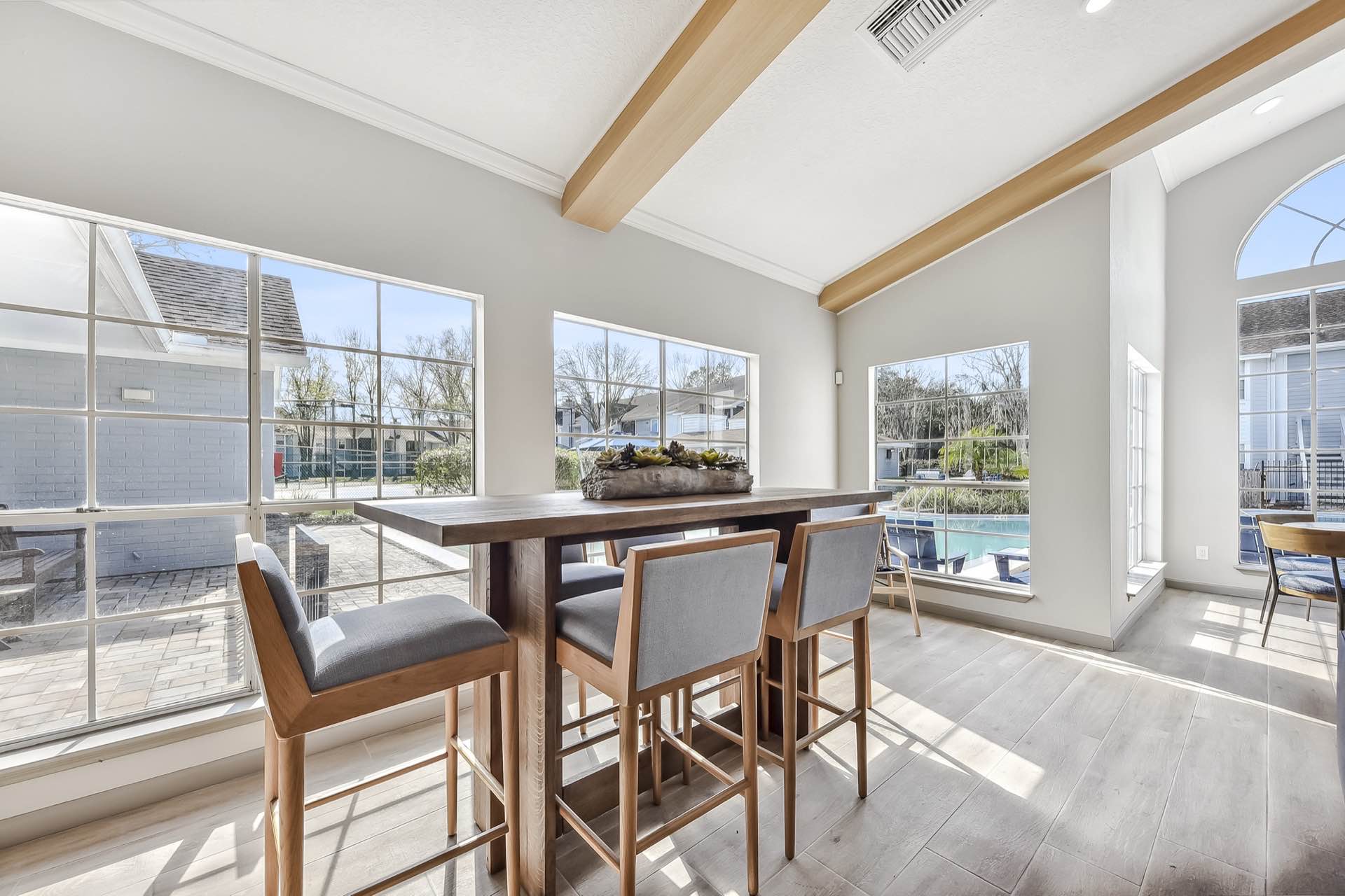 clubhouse with view of pool and large windows