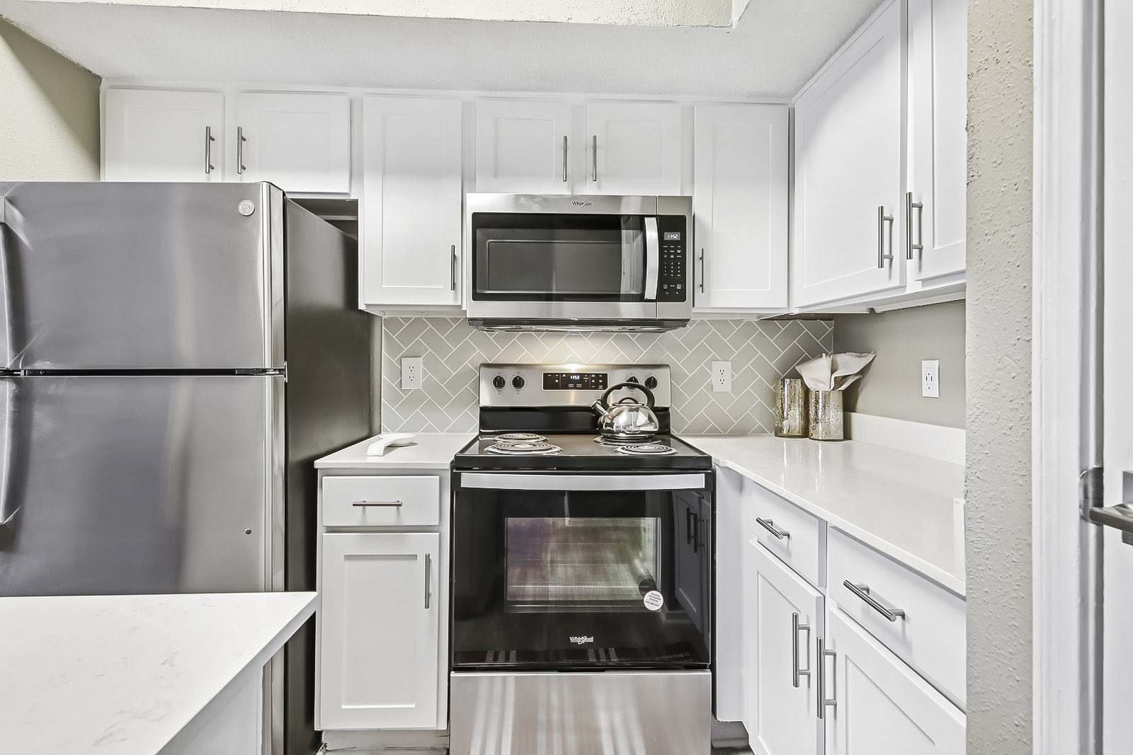 stainless steel appliances including electric range and overhead microwave