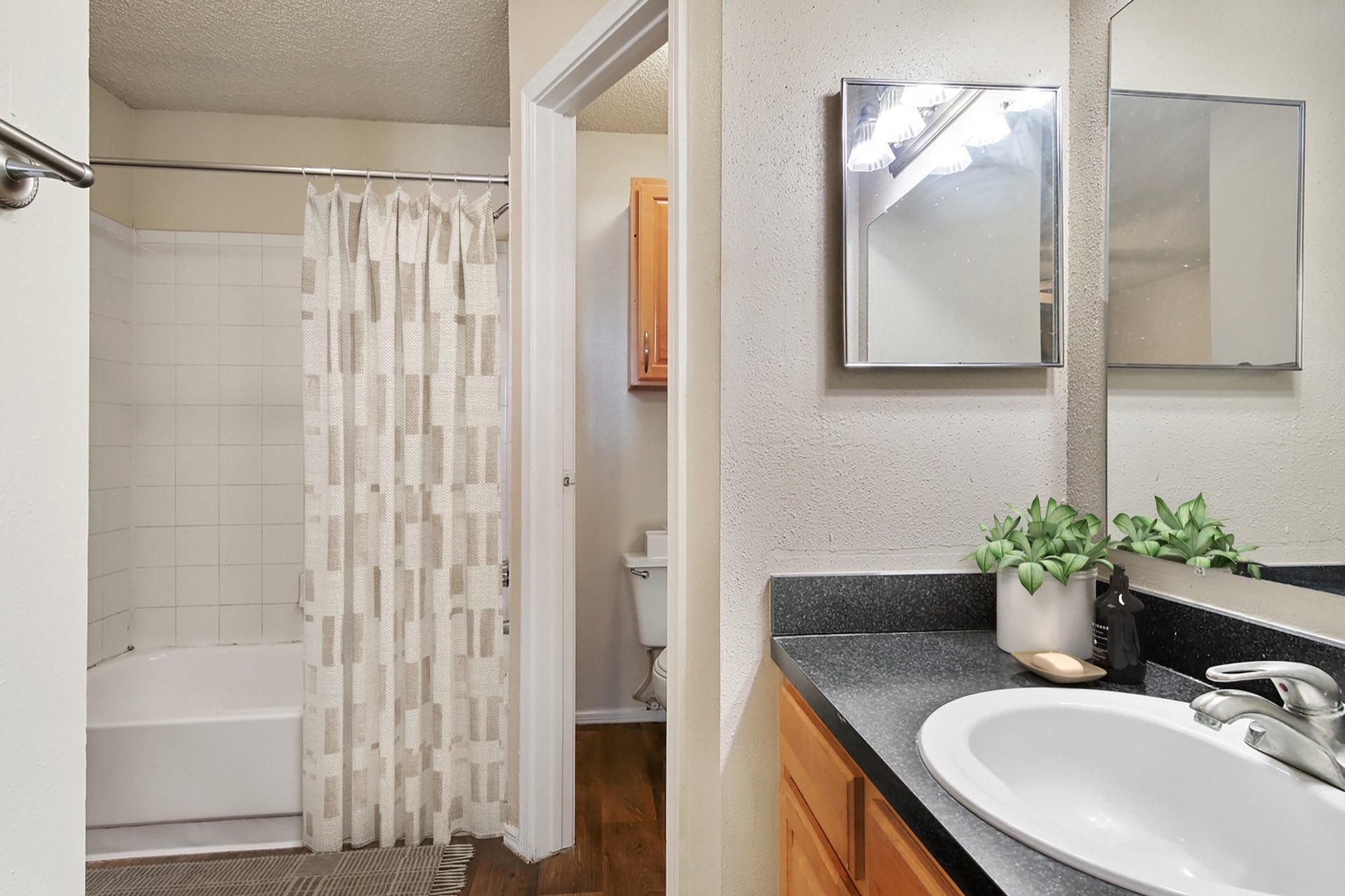 bathroom with laminate countertops and separate toilet closet