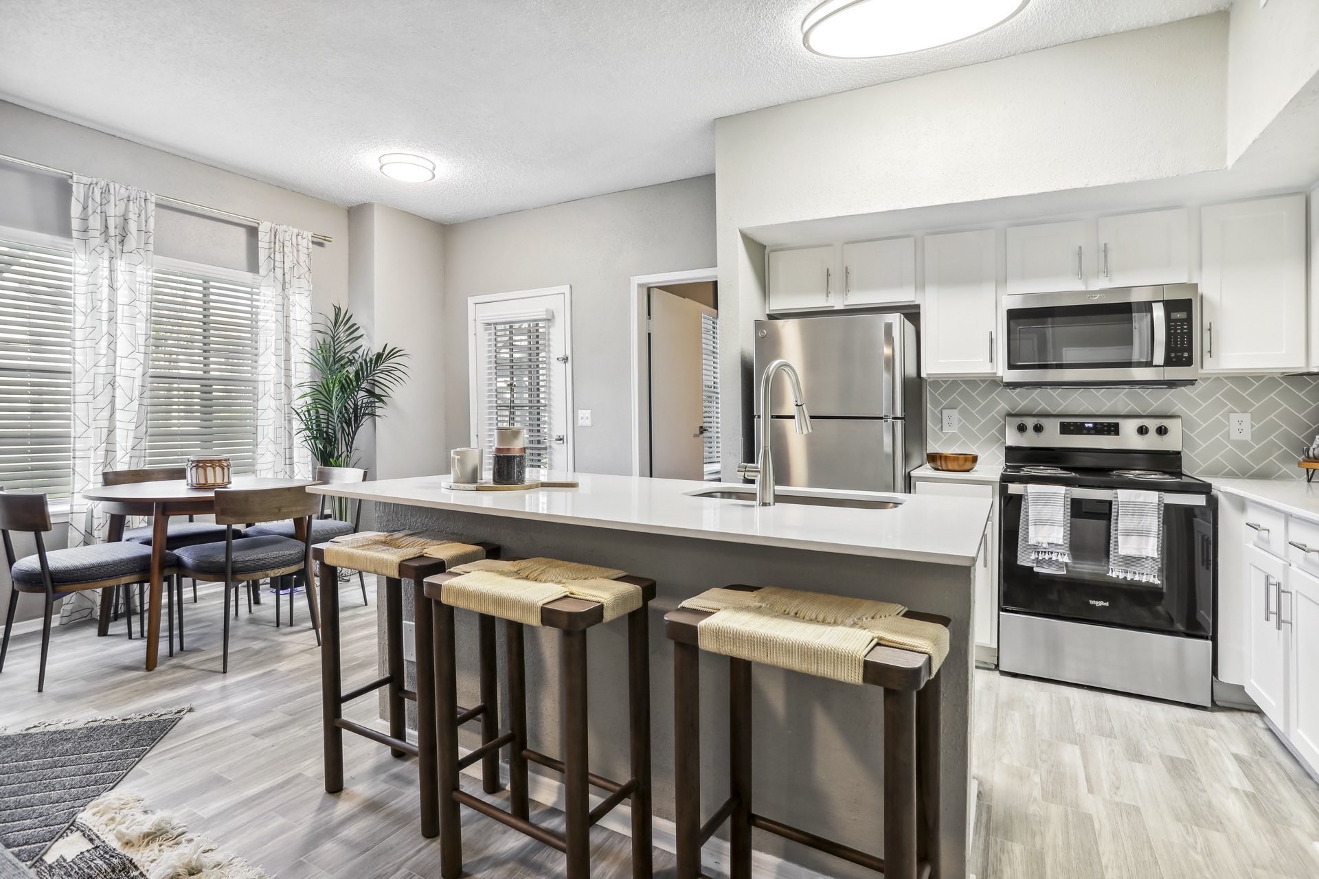 open kitchen with island seating and wood style flooring and dining space