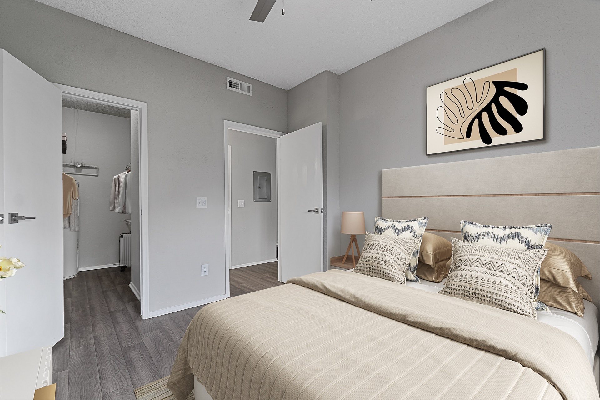 bedroom with walk-in closet and wood style flooring
